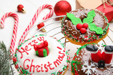 Grid with tasty Christmas donuts on white background, closeupの写真素材