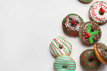 Different tasty Christmas donuts on white backgroundの写真素材