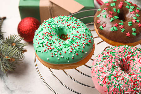 Grid with tasty Christmas donuts on light background, closeupの写真素材