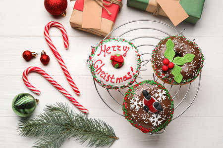 Grid with tasty Christmas donuts on white backgroundの写真素材