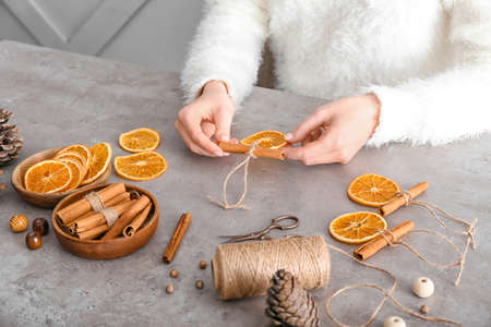 Woman making handmade Christmas toys at tableの写真素材