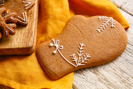 Tasty gingerbread cookie on light wooden background, closeupの写真素材
