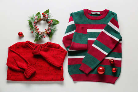 Stylish children's clothes and Christmas decor on white background
