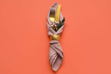 Stylish cutlery with flowers on color background