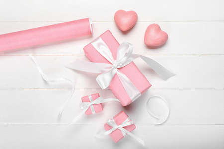Gift boxes for Valentine's Day on white wooden background