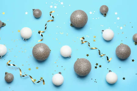 Christmas balls and confetti on blue background