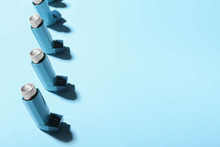 Asthma inhalers on blue background