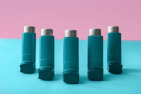 Asthma inhalers on color background