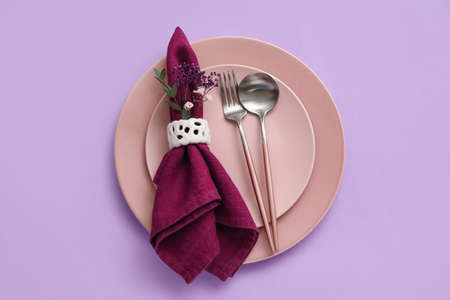 Stylish table setting on purple background