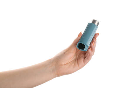 Female hand with asthma inhaler on white background