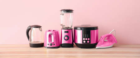 Different household appliances on table in room