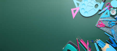 Set of school stationery on blackboard