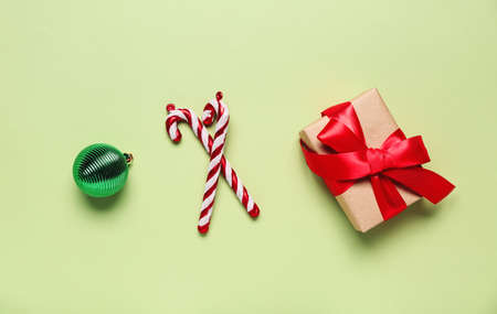 Gift box and Christmas decorations on green backgroundの写真素材