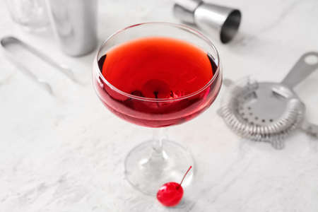 Glass of tasty Manhattan cocktail on light background, closeupの写真素材