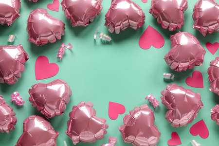Frame made of heart-shaped air balloons for Valentine's day on color backgroundの写真素材