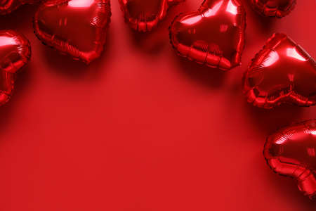 Heart-shaped air balloons for Valentine's day on red background