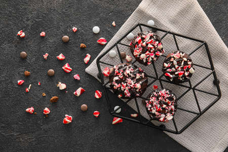 Grid with tasty candy cane cookies on black backgroundの写真素材