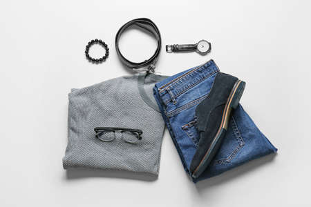 Male clothes, shoes and accessories on light background