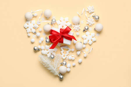 Heart shape made of Christmas decor on yellow backgroundの写真素材