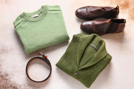 Male sweaters, shoes and belt on grunge backgroundの写真素材