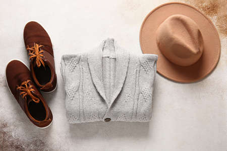Stylish male sweater, shoes and felt hat on grunge backgroundの写真素材