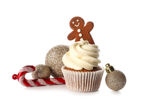 Tasty cupcake with gingerbread cookie and Christmas decor on white backgroundの写真素材