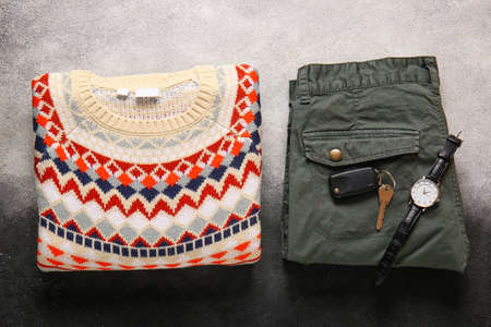 Male sweater, pants, car keys and wristwatch on white and black backgroundの写真素材