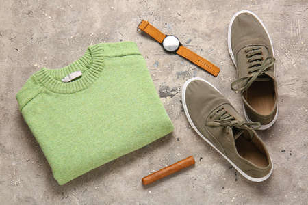 Male sweater, shoes, wristwatch and cigar on grunge backgroundの写真素材