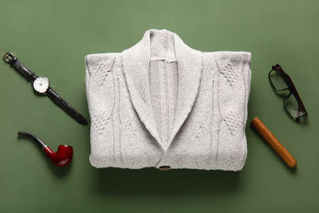 Male sweater and accessories on green backgroundの写真素材