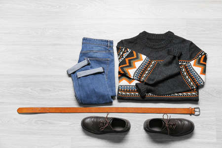 Male clothes, belt and leather shoes on light wooden backgroundの写真素材