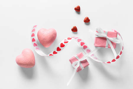 Presents for Valentine's Day and hearts on light background