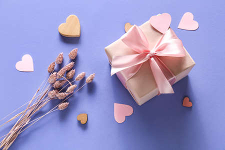 Gift for Valentine's day, decorative hearts and dry flowers on color backgroundの写真素材