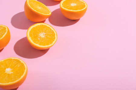 Fresh cut oranges on pink background, closeupの写真素材