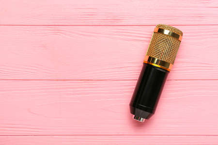 New modern microphone on color wooden backgroundの写真素材