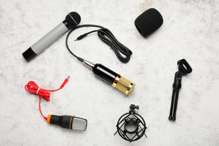 Modern microphones on light background