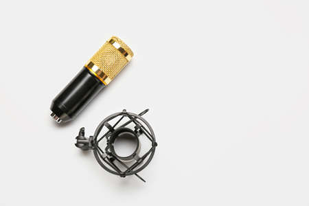 Modern microphone with stand on light backgroundの写真素材