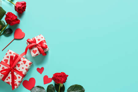 Gifts for Valentine's Day and rose flowers on color backgroundの写真素材