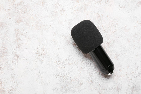 Modern microphone on light backgroundの写真素材