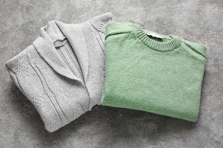 Different stylish sweaters on grunge backgroundの写真素材