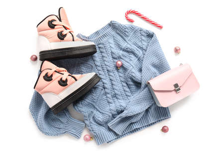 Knitted sweater, stylish shoes, bag and Christmas decor on white background