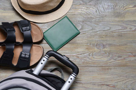 Accessories for travel and backpack on gray wooden backgroundの写真素材