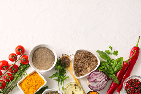 Composition with aromatic spices, herbs and vegetables on light backgroundの写真素材