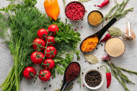 Different spices, vegetables and herbs on light backgroundの写真素材