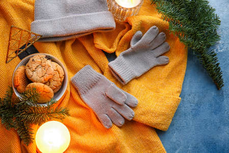 Warm gloves, sweater and cookies on blue backgroundの写真素材