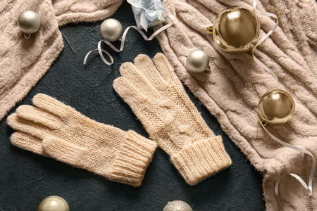 Warm gloves and Christmas decor on black backgroundの写真素材