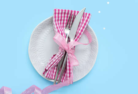 Beautiful table setting for Valentine's Day on blue background