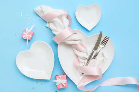 Beautiful table setting for Valentine's Day on blue backgroundの写真素材