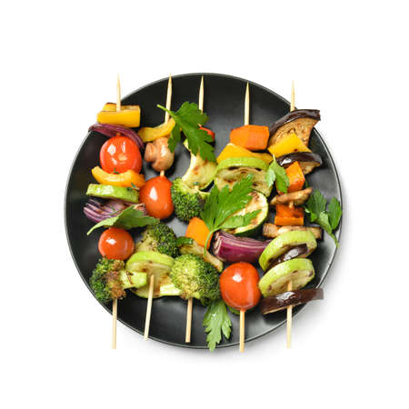 Plate with tasty vegetable skewers on white backgroundの写真素材