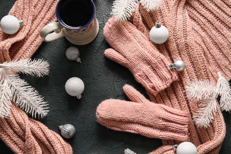 Warm gloves, scarf and Christmas decor on black backgroundの写真素材