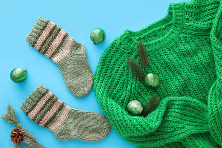 Stylish clothes and Christmas decor on blue backgroundの写真素材